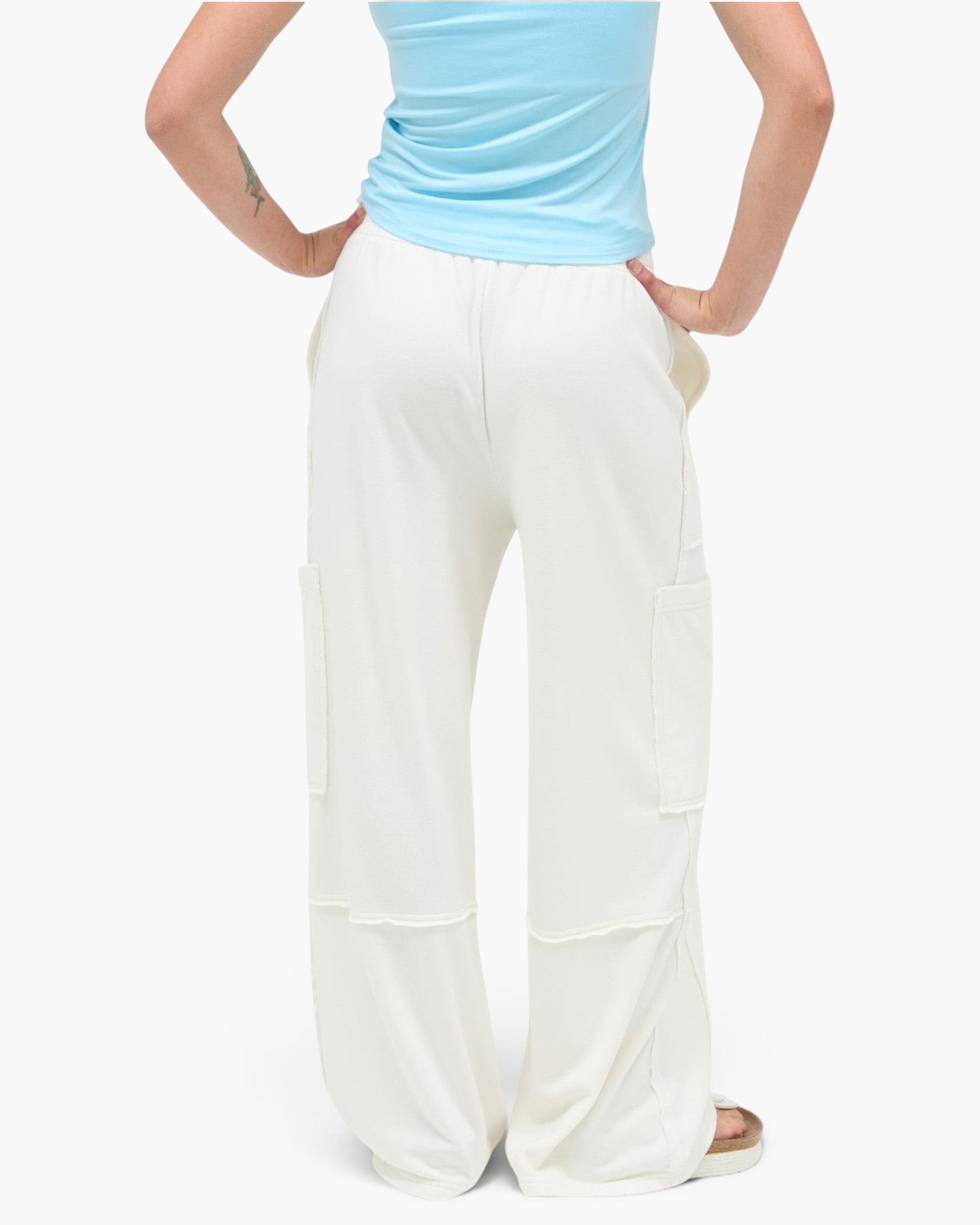 Beach Rose Co. white mineral wash wide leg cargo pants with raw edge pockets and elastic waistband, back view