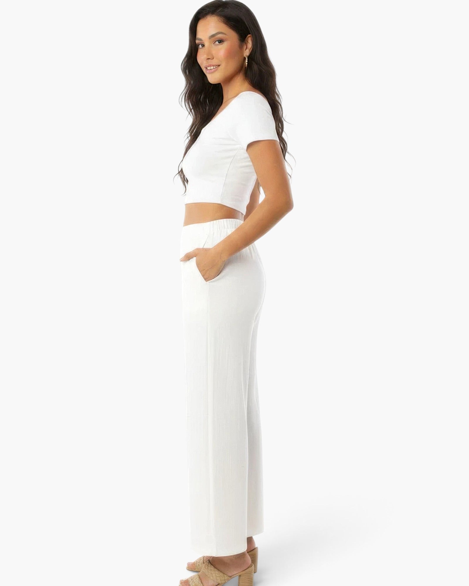 Beach Rose Co. white wide-leg cotton pants with side pockets worn by a woman in a relaxed fit style