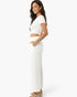 Beach Rose Co. white wide-leg cotton pants with side pockets worn by a woman in a relaxed fit style