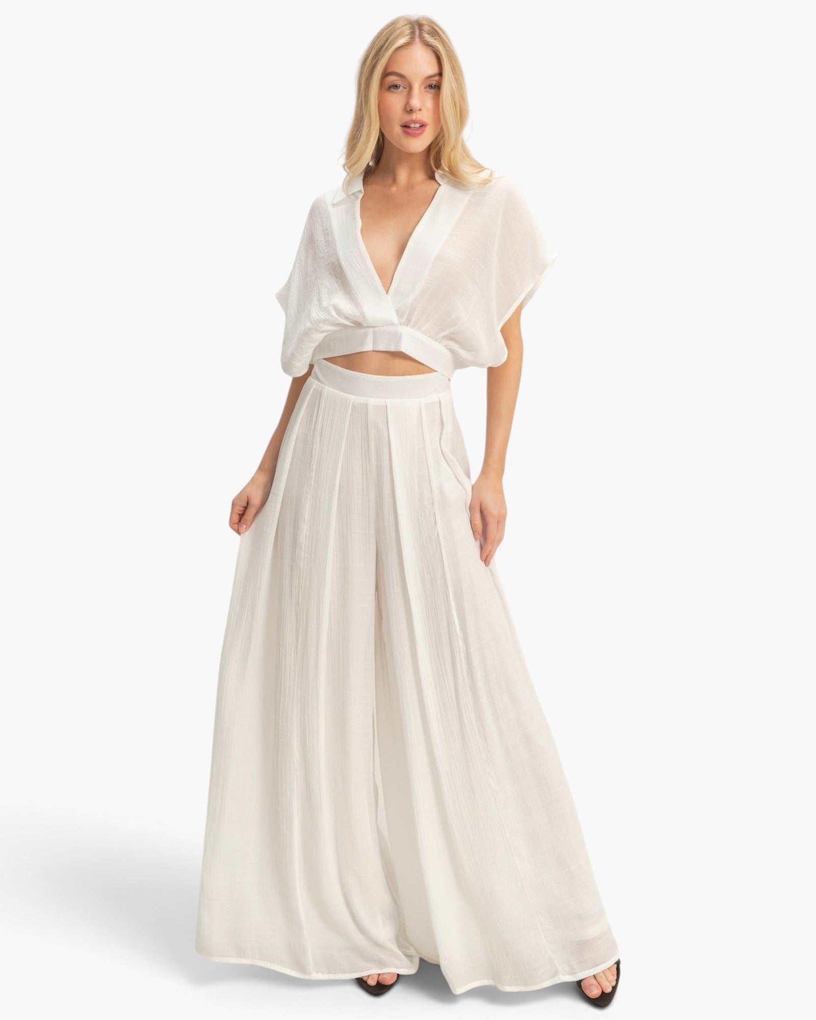 Beach Rose Co. white two-piece set with a collared cropped wrap top and flowing pleated wide-leg pants on a model.