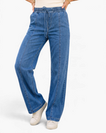 Beach Rose Co. medium wash wide leg denim jeans with an elastic drawstring waistband and vertical front seam details.