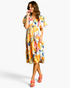 Beach Rose Co. yellow midi dress with abstract print, flutter sleeves, and tiered skirt worn by a smiling model.