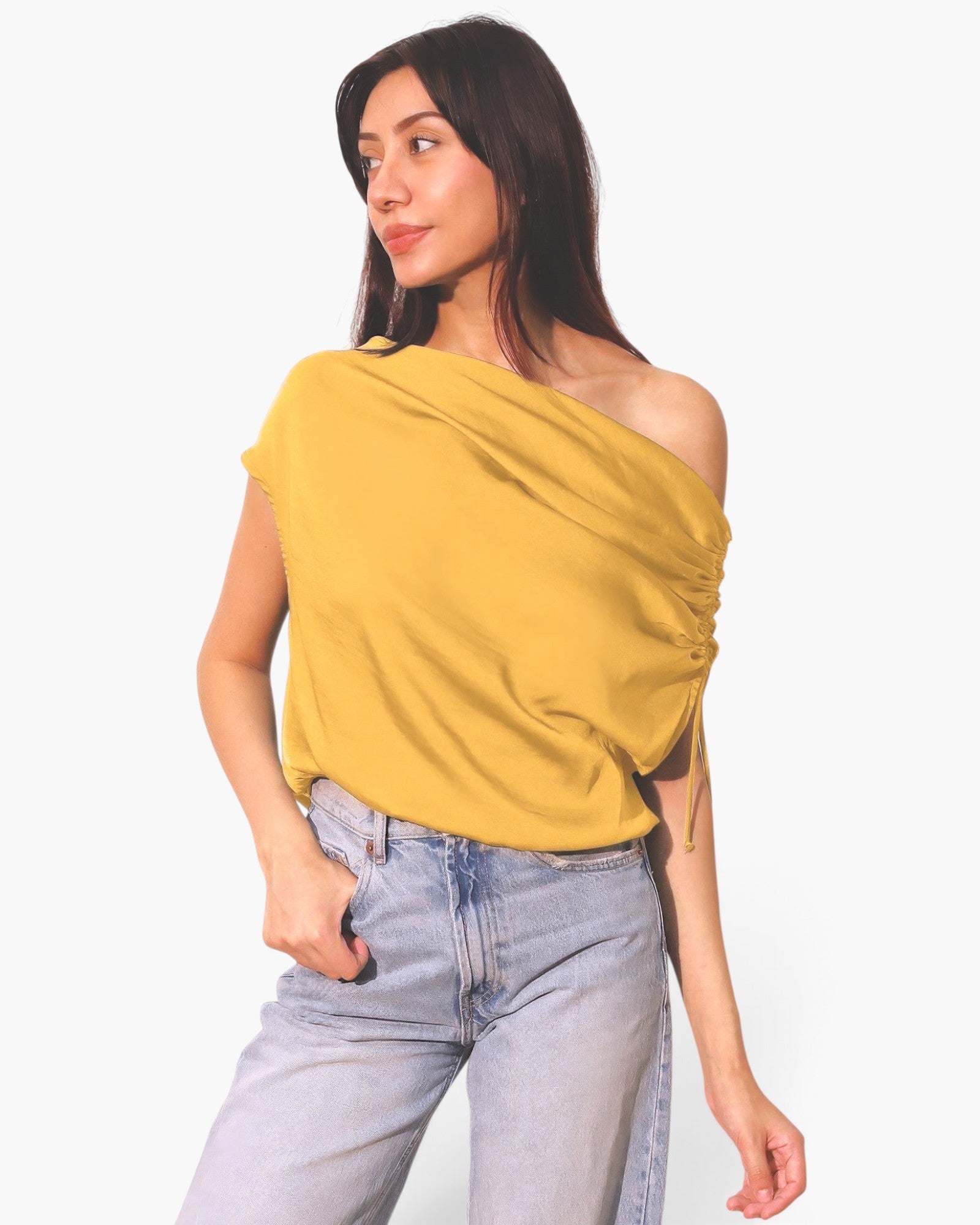 Beach Rose Co. yellow asymmetrical drawstring top with a washed silk finish worn by a model with light wash jeans.