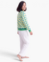 Beach Rose Co. yellow polyester sweatshirt with blue polka dots and green striped trim, worn by a smiling woman.