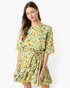Beach Rose Co. yellow floral mini dress with elbow-length sleeves and a braided waist tie on a female model