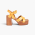 Beach Rose Co. yellow leather platform sandals with cross-straps, metal stud accents, and a block heel.