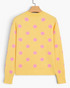 Beach Rose Co. yellow knit cardigan with pink polka dots, long sleeves, and ribbed hem, back view.