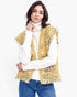 Beach Rose Co. yellow plaid tweed vest with frayed raw edges and buttoned flap pockets worn over a white turtleneck.