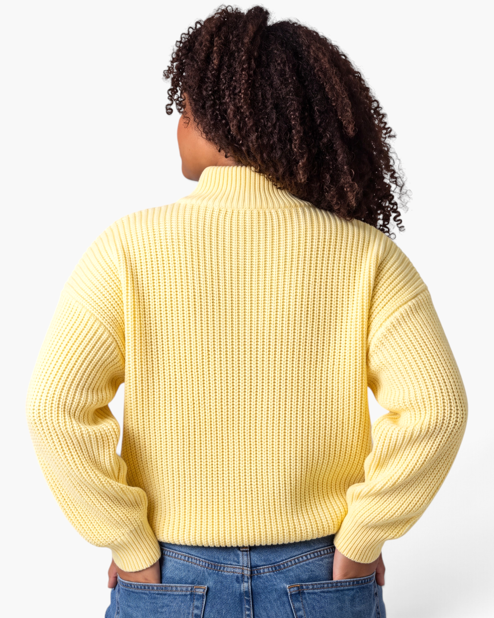 Beach Rose Co. yellow ribbed knit sweater with a stand collar and dropped shoulders, shown from the back.
