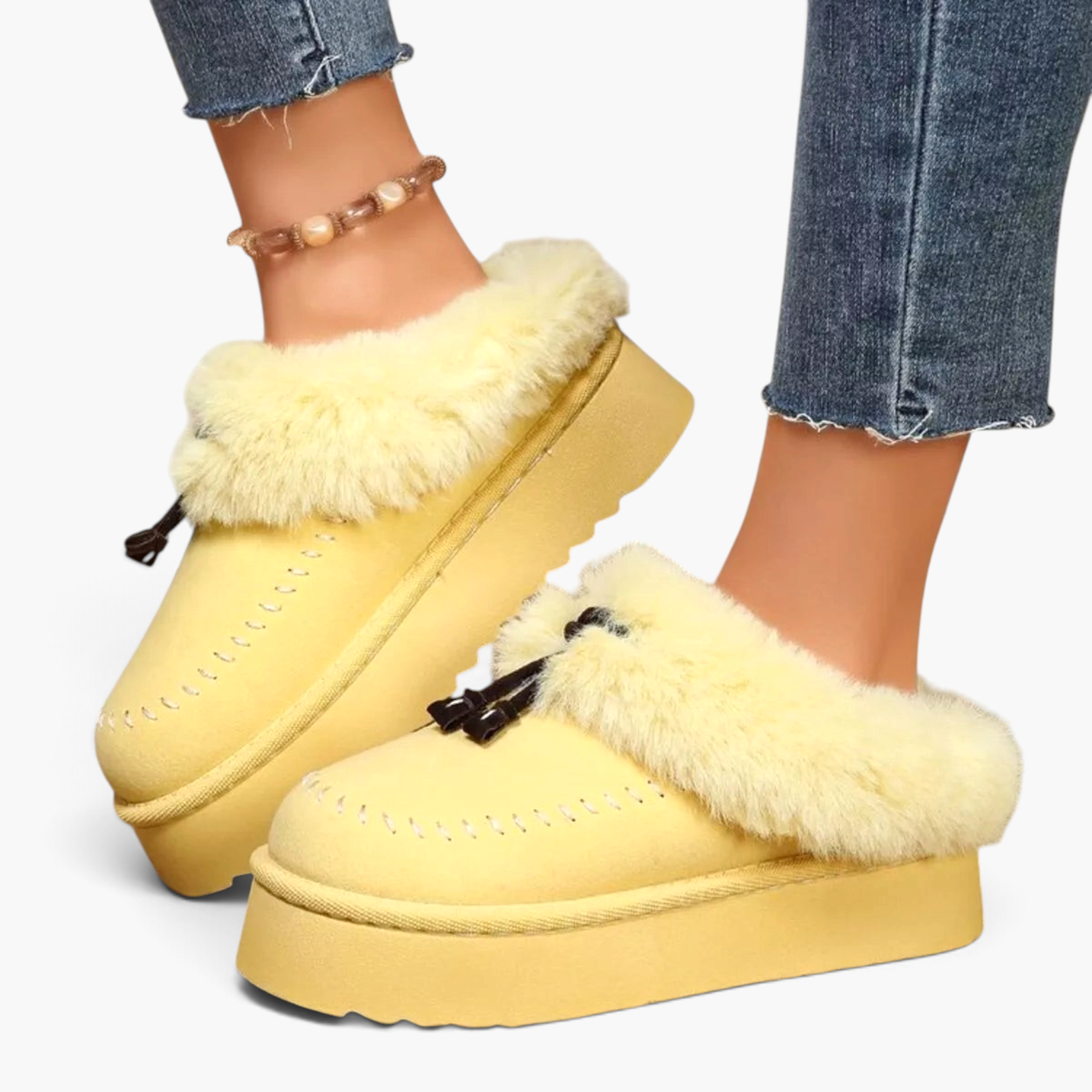 Beach Rose Co. yellow suede platform clogs with plush faux fur trim, moccasin stitching, and decorative tassels.