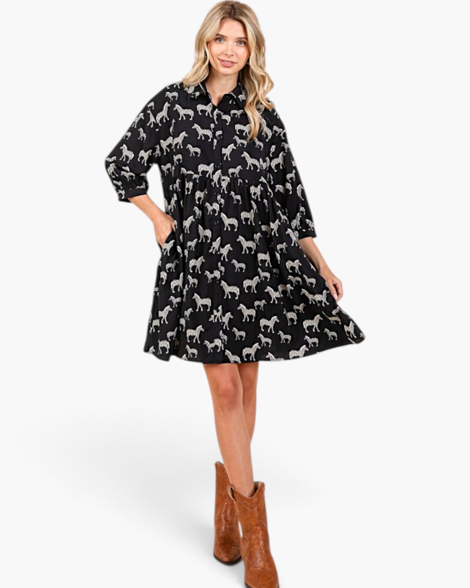 Beach Rose Co. black and white zebra print babydoll dress with balloon sleeves and pockets worn by a blonde model.