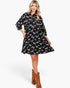 Beach Rose Co. black and white zebra print babydoll dress with balloon sleeves and pockets worn by a blonde model.