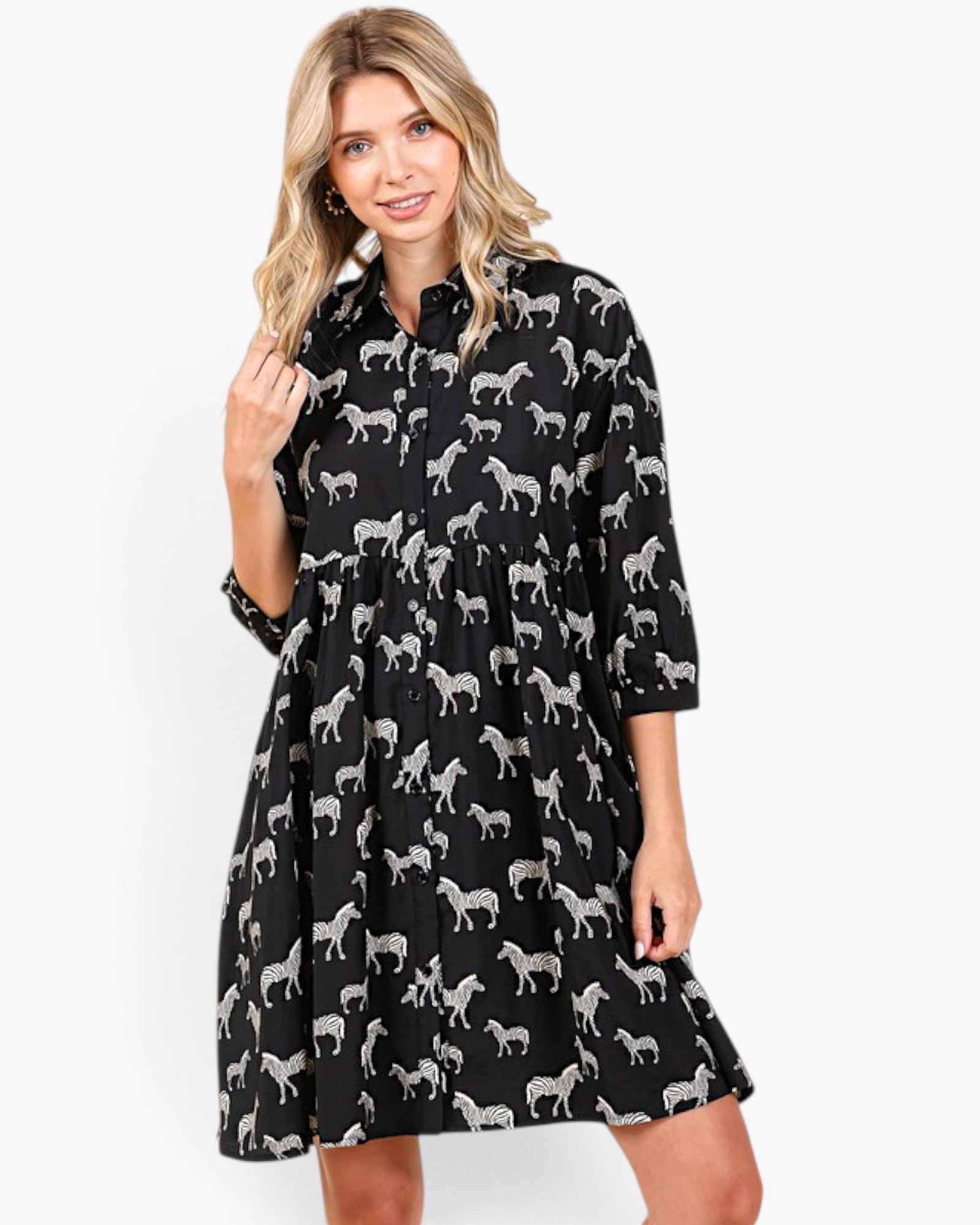 Model wearing a Beach Rose Co. black and white zebra print babydoll dress with a collar and button-front design.