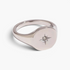 Beach Rose Co. gold-plated signet ring with a rounded face, engraved starburst, and a clear zircon centerpiece.