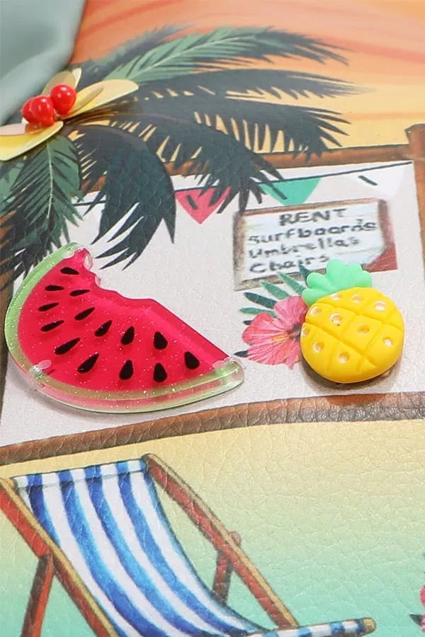 Decorative items including a watermelon slice, pineapple, and palm leaves on a tropical-themed background.