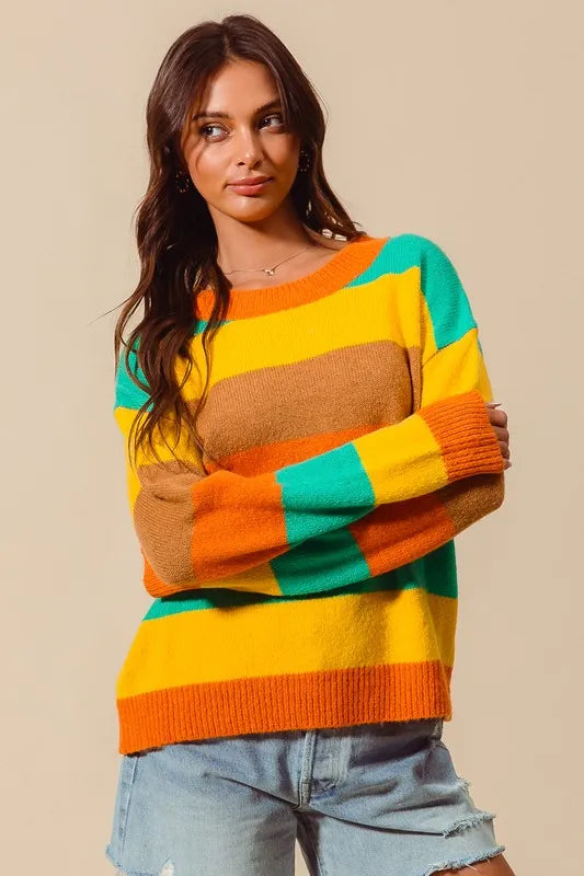 Woman wearing a colorful striped sweater against a beige background