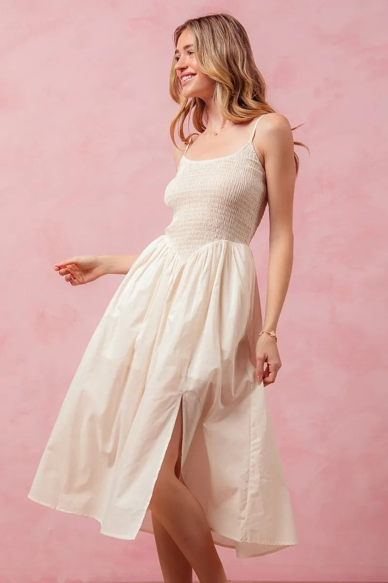 Woman wearing a white dress against a pink background