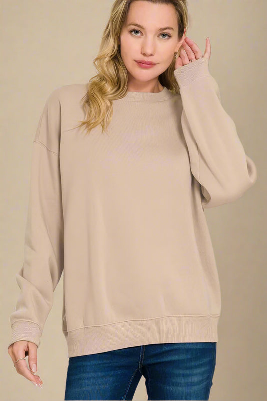 Woman wearing a beige sweater on a beige background