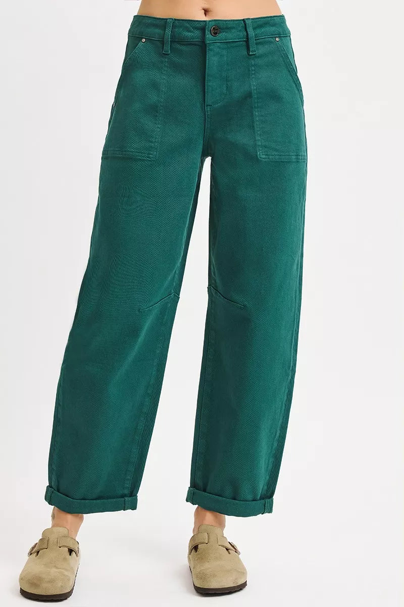 Green pants worn by a person on a white background