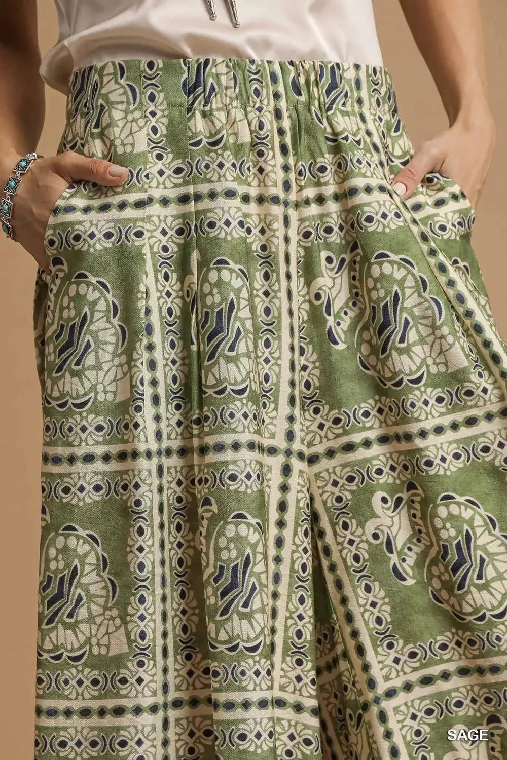 Green patterned skirt with turtle design on a beige background