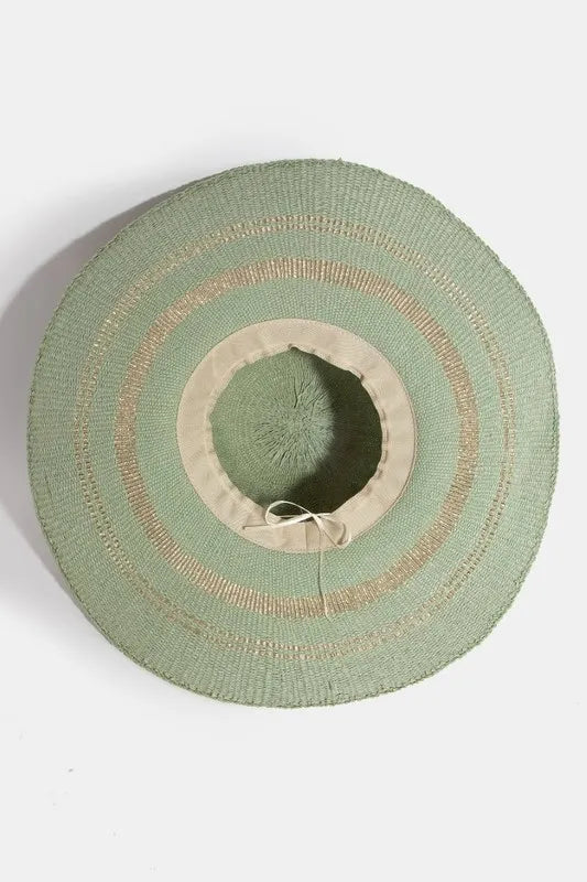 Green straw hat with beige trim on a white background