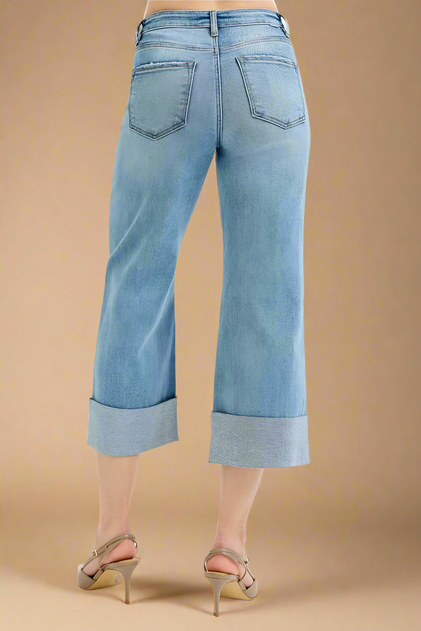 Light blue jeans worn by a person on a white background