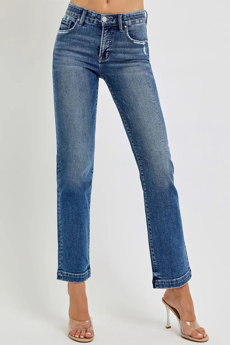 Blue jeans worn by a person on a white background
