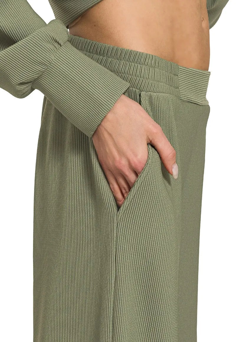 Green ribbed pants with a belt on a white background