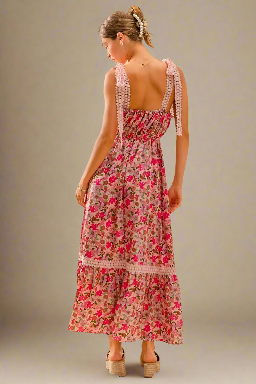 Woman wearing a floral dress with a plain background