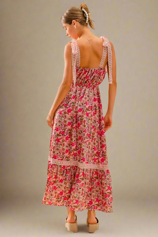 Woman wearing a floral dress with a plain background