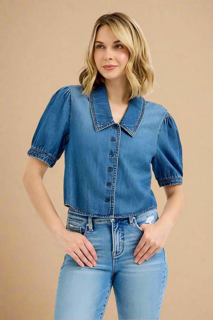 Woman wearing a denim shirt and jeans on a white background
