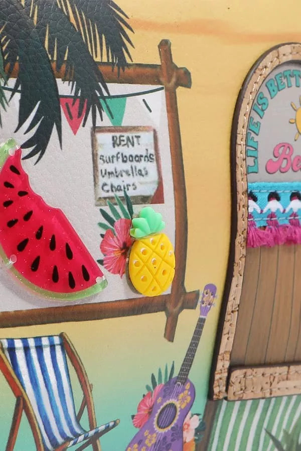 Decorative scene with a beach-themed board, guitar, and lounge chair.