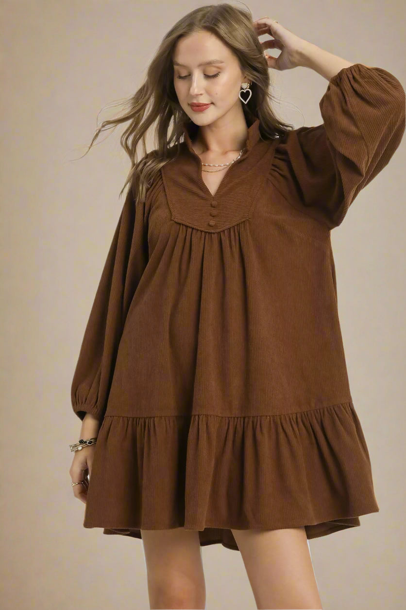 Woman wearing a brown dress on a white background