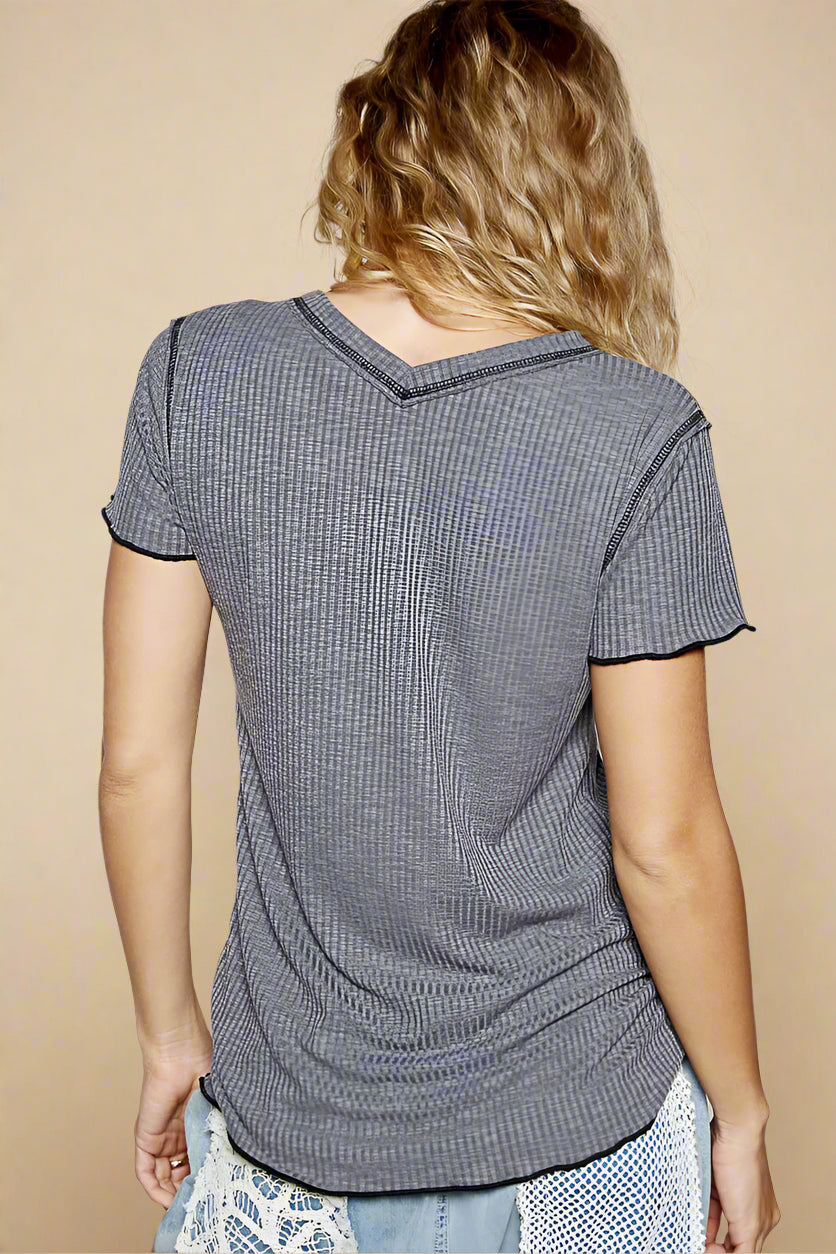 Person wearing a gray textured t-shirt against a plain background