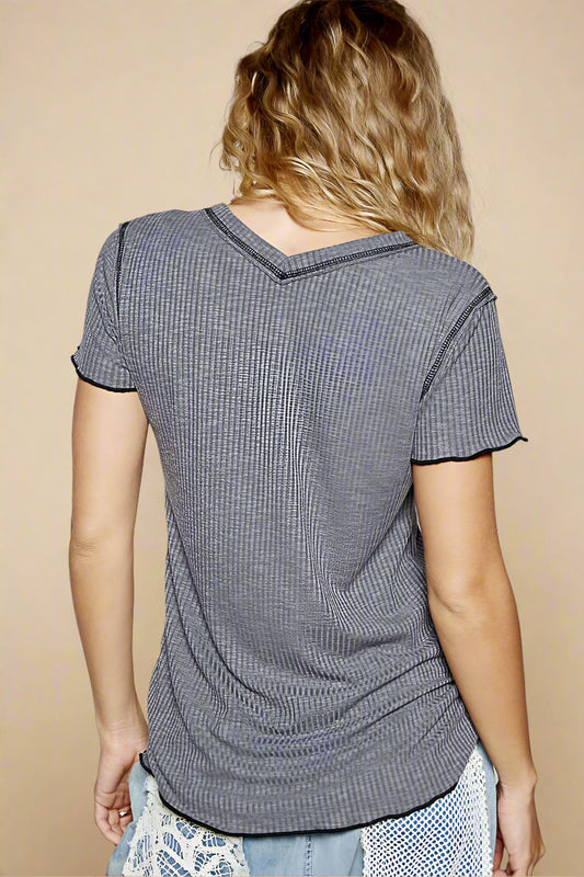 Person wearing a gray textured t-shirt against a plain background