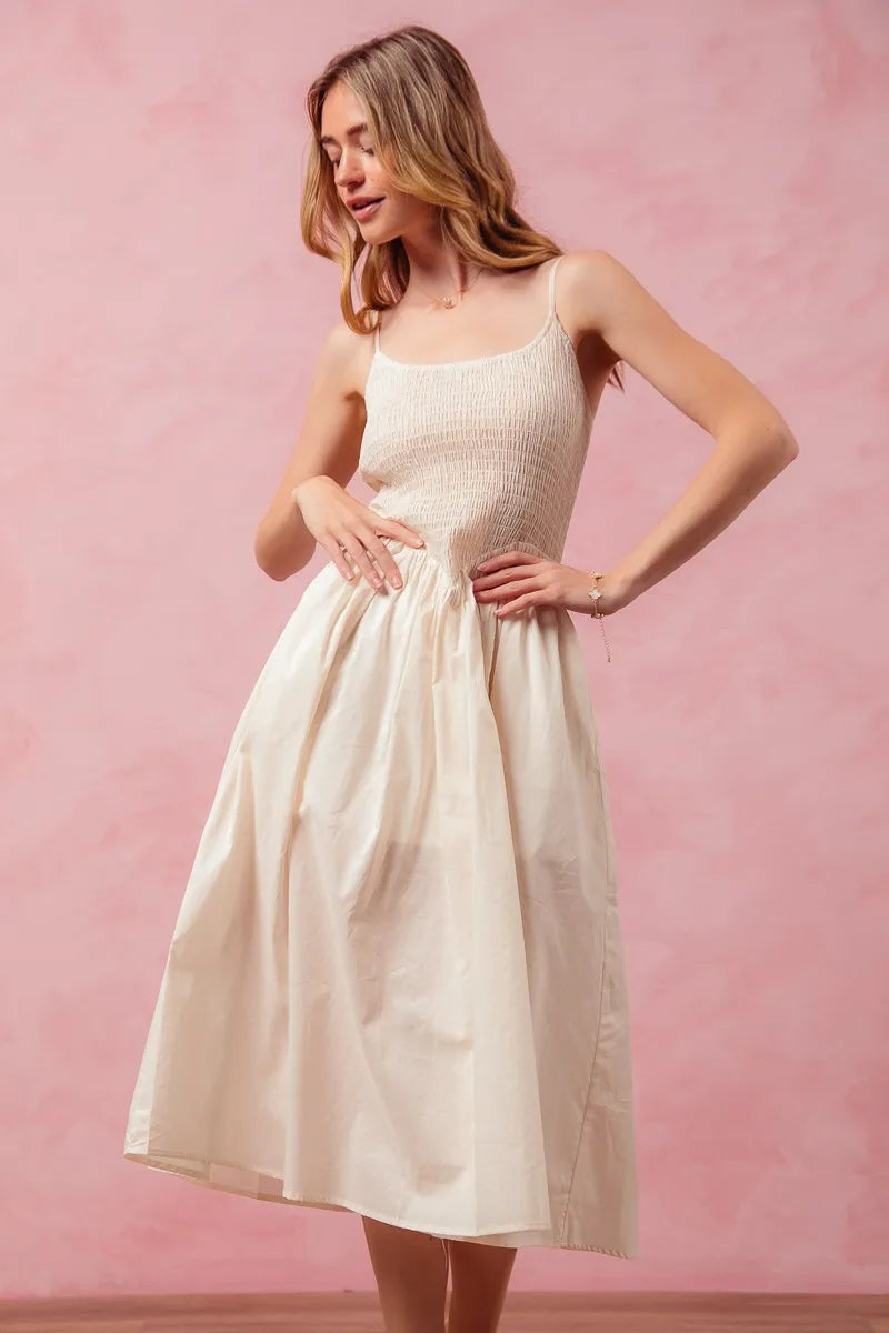 Woman wearing a white dress against a pink background