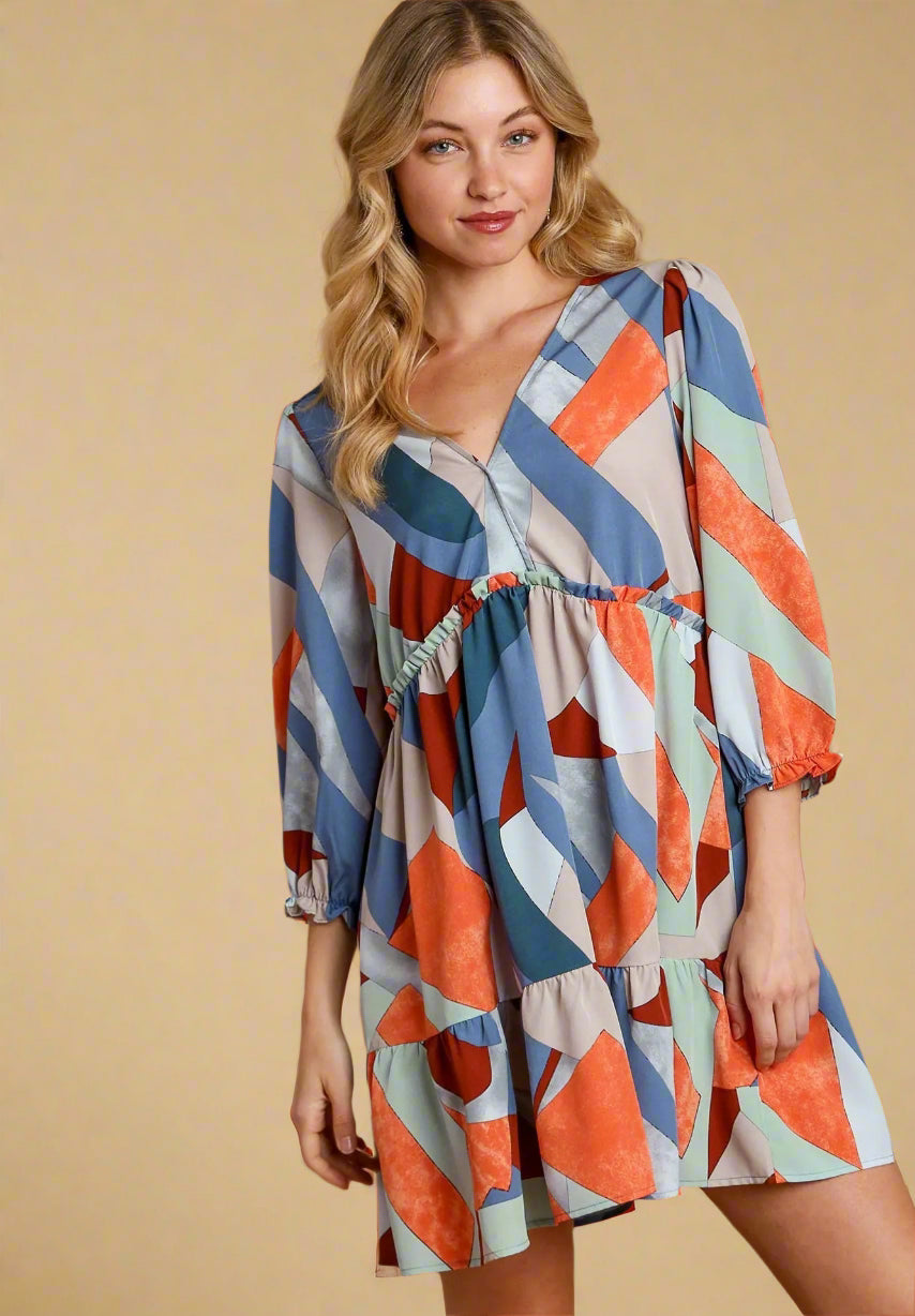 Woman wearing a colorful geometric pattern dress on a beige background