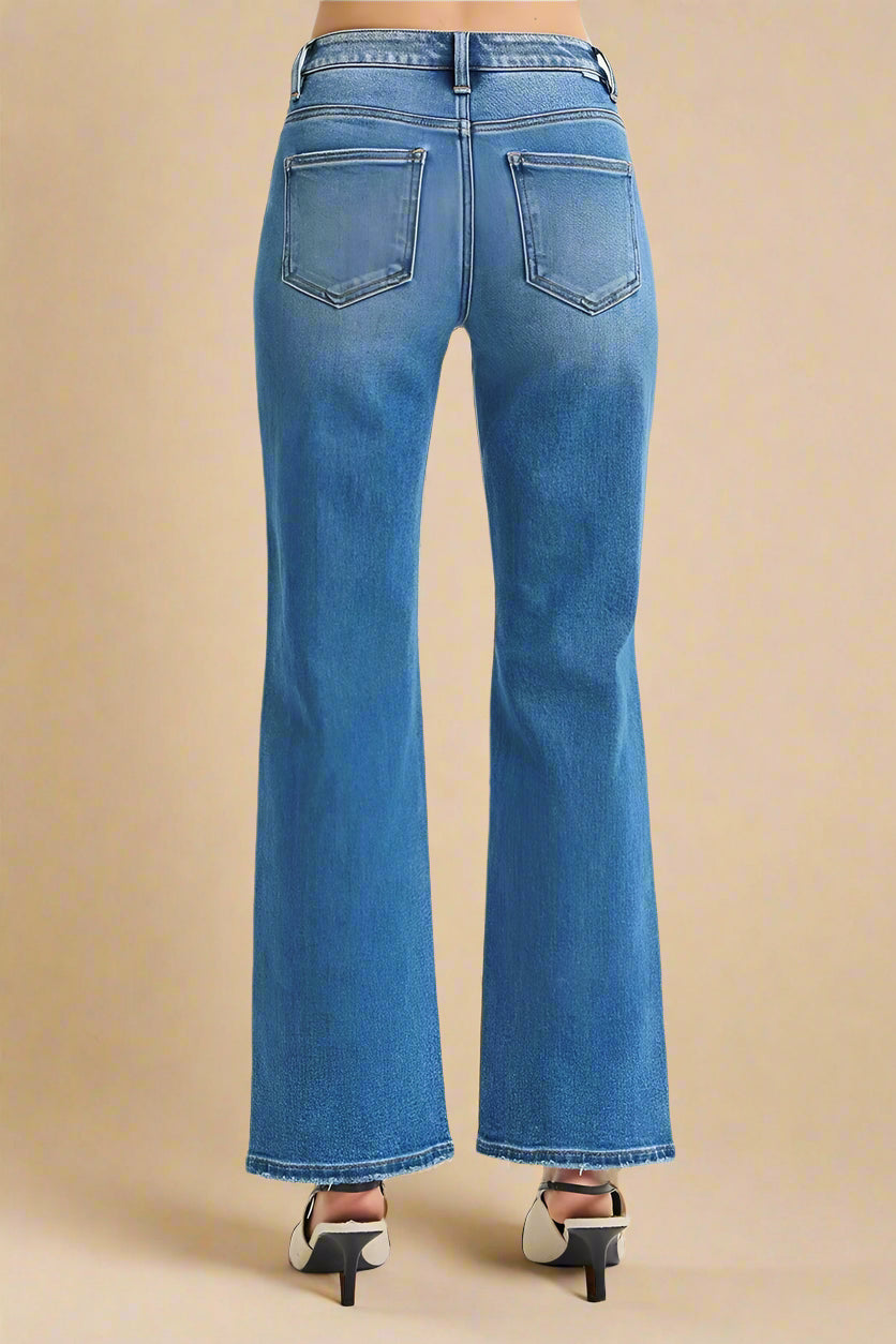 Blue jeans worn by a person on a white background