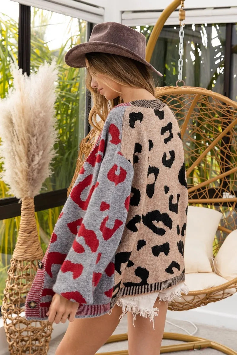 Woman wearing a patterned cardigan with a blurred background