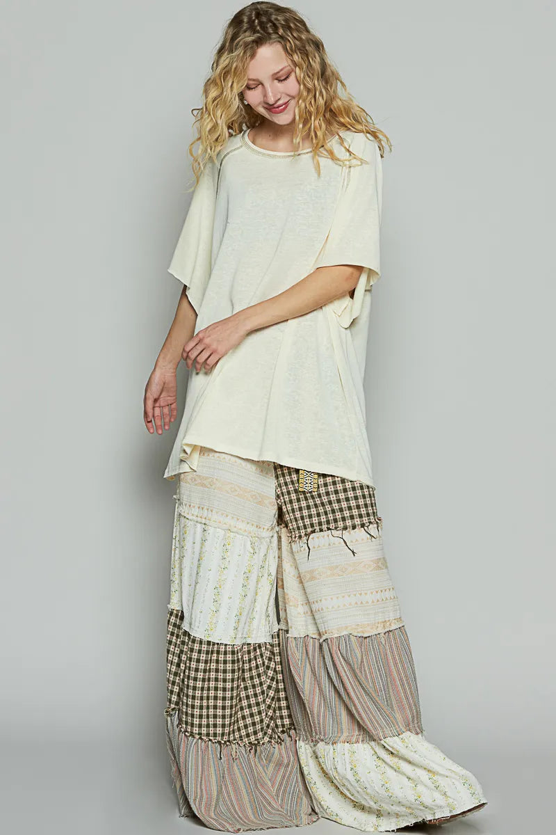 Woman wearing a layered outfit with a plain background