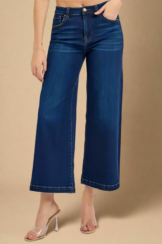 Person wearing blue jeans on a beige background