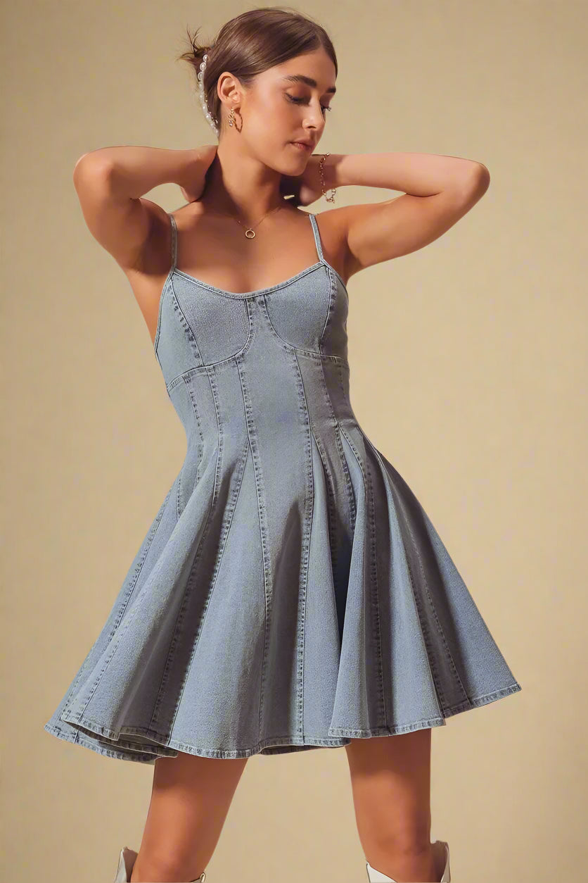 Woman wearing a denim dress against a beige background