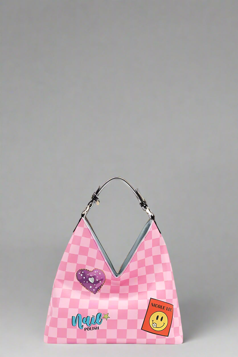 Pink checkered bag with heart and smiley face patches on a white background