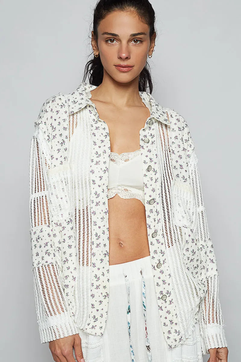 Woman wearing a white floral lace cover-up over a white bikini on a gray background