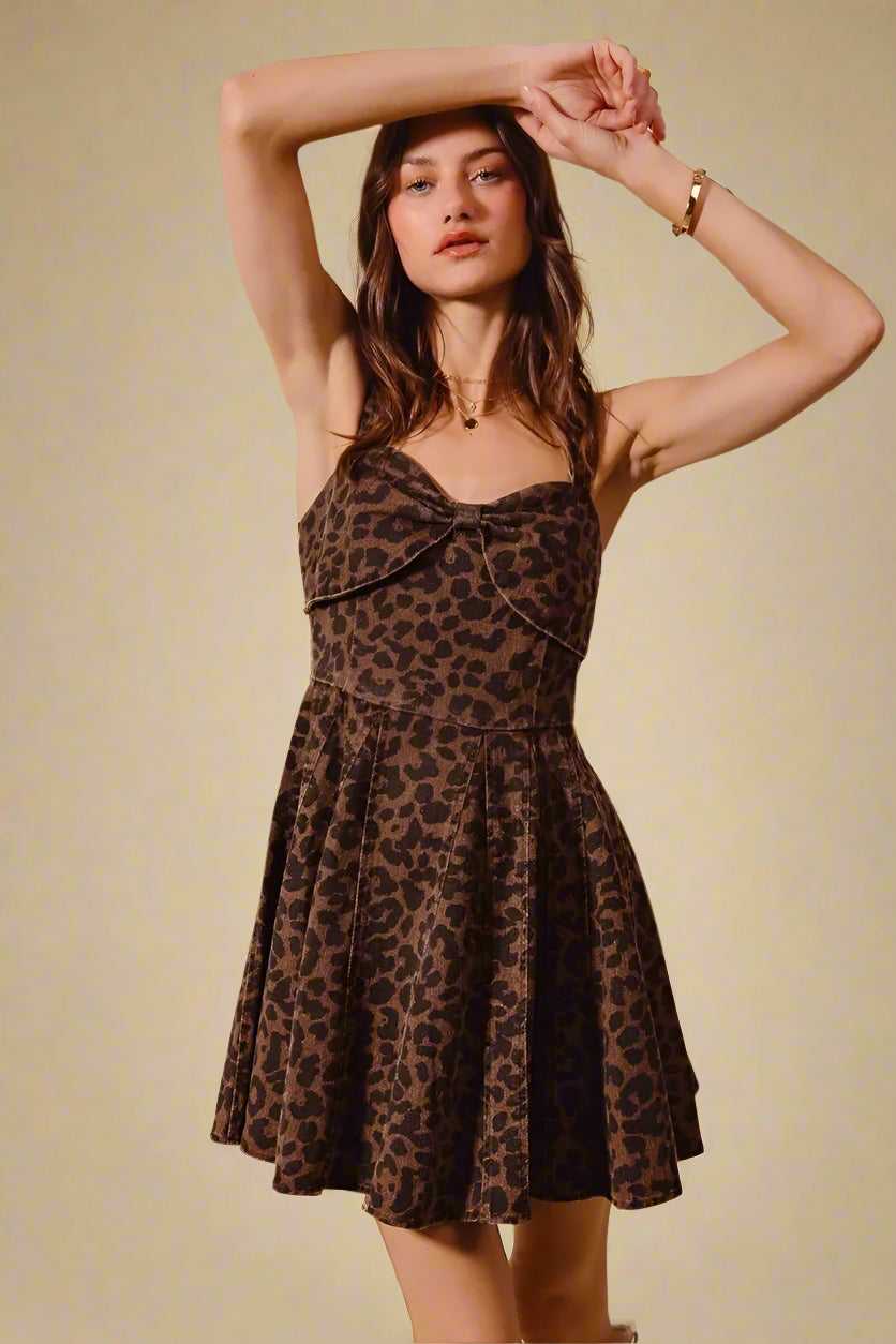 Woman wearing a leopard print dress against a beige background