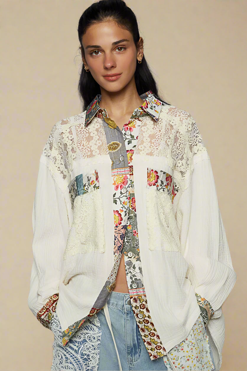 Woman wearing a floral and lace patterned blouse with a gray background