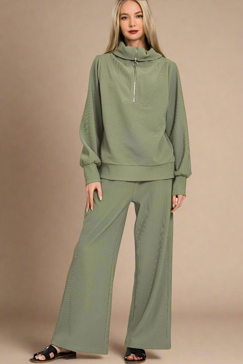 Woman wearing a light olive green outfit on a beige background