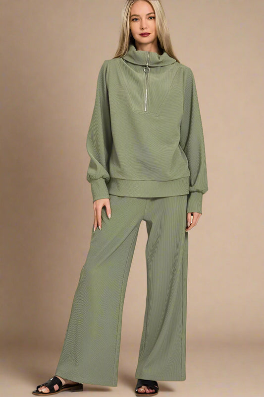 Woman wearing a light olive green outfit on a beige background