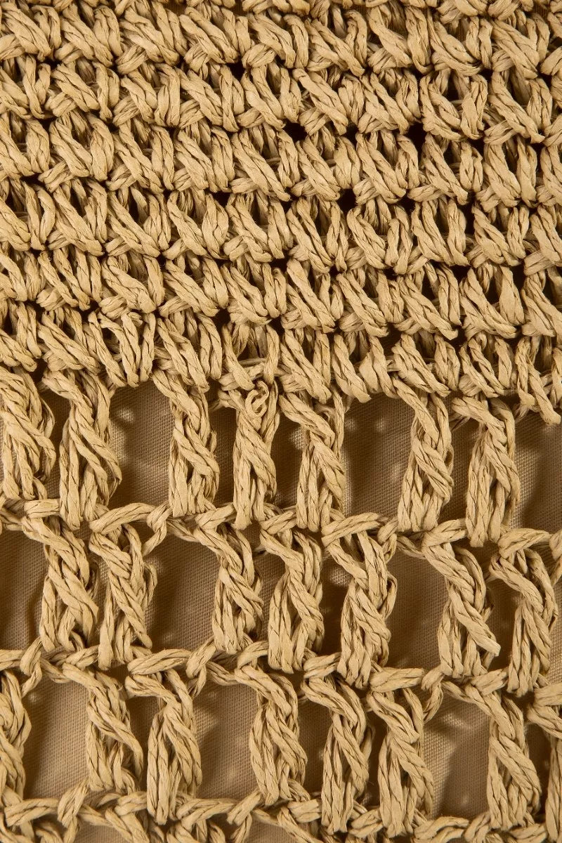 Close-up of a textured beige fabric with a woven pattern