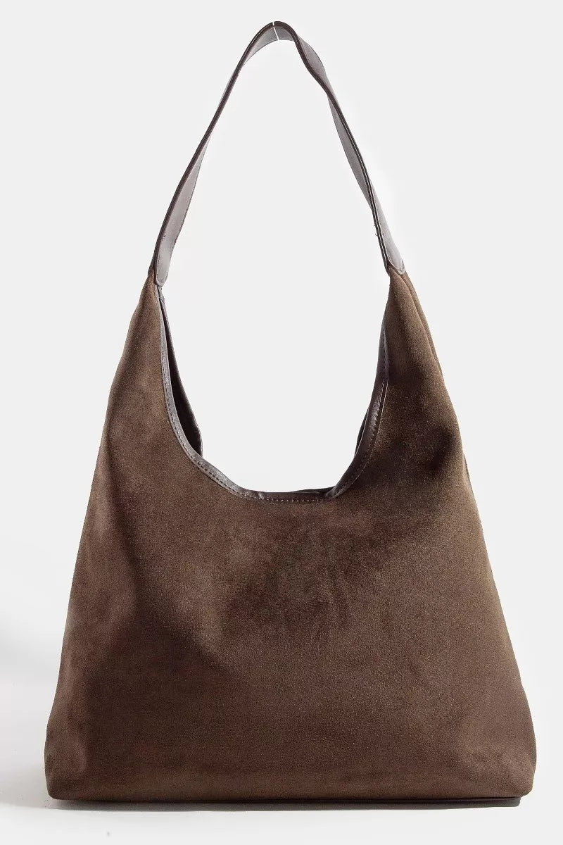 Brown suede handbag on a white background